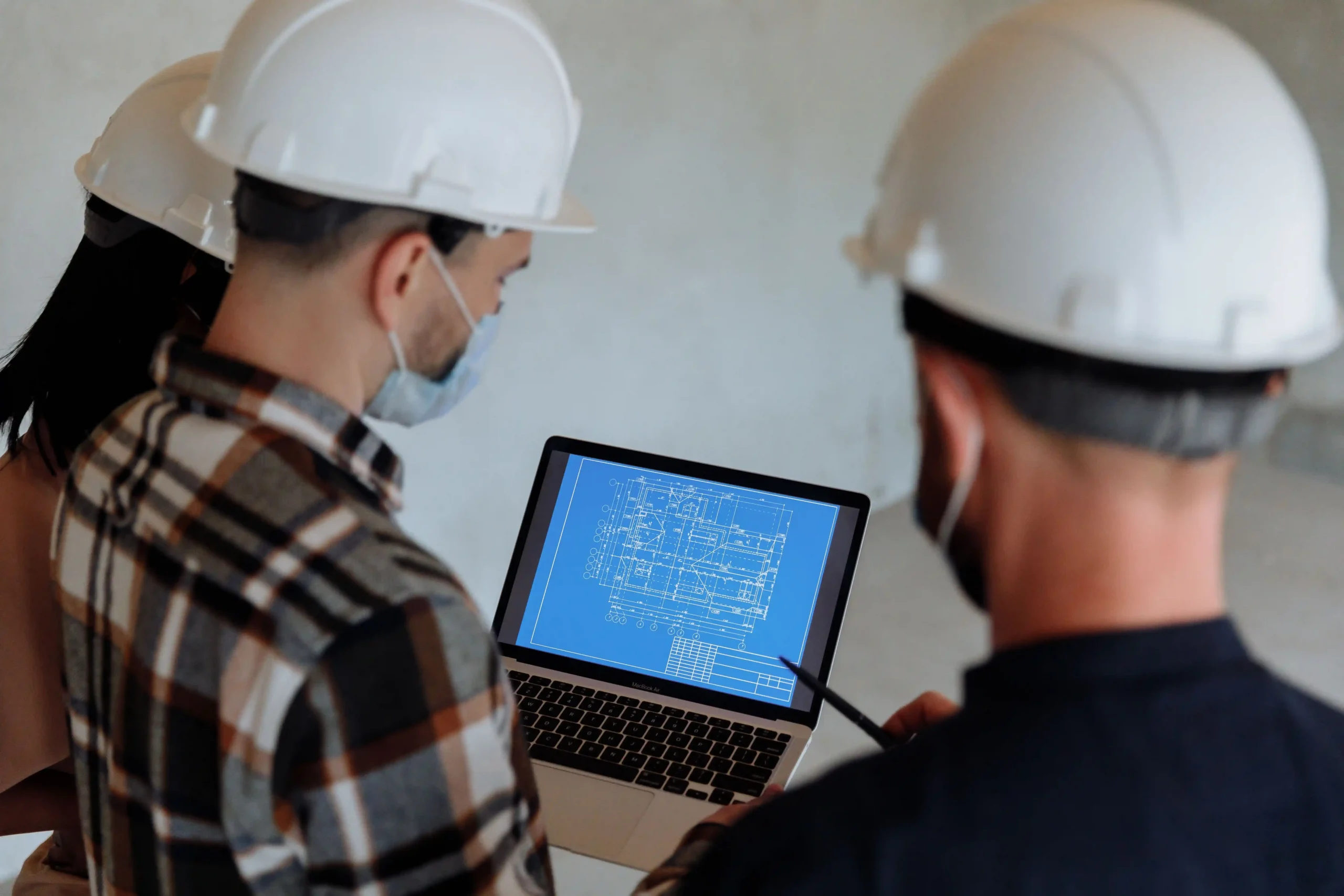 Engineers reviewing a communication system design on a construction site